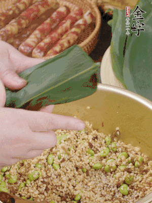 粽葉往下折，完全蓋住，兩側(cè)捏緊。
