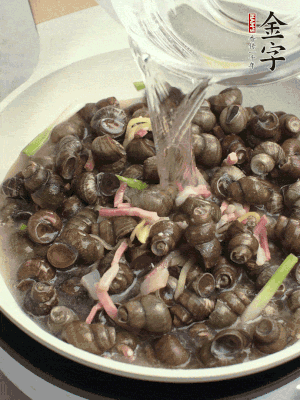 倒處理干凈的螺螄翻炒，加3勺料酒。加清水蓋過螺螄，中火蓋蓋煮5分鐘。